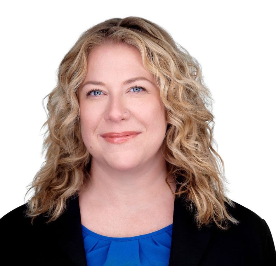 Professional headshot of smiling blonde woman