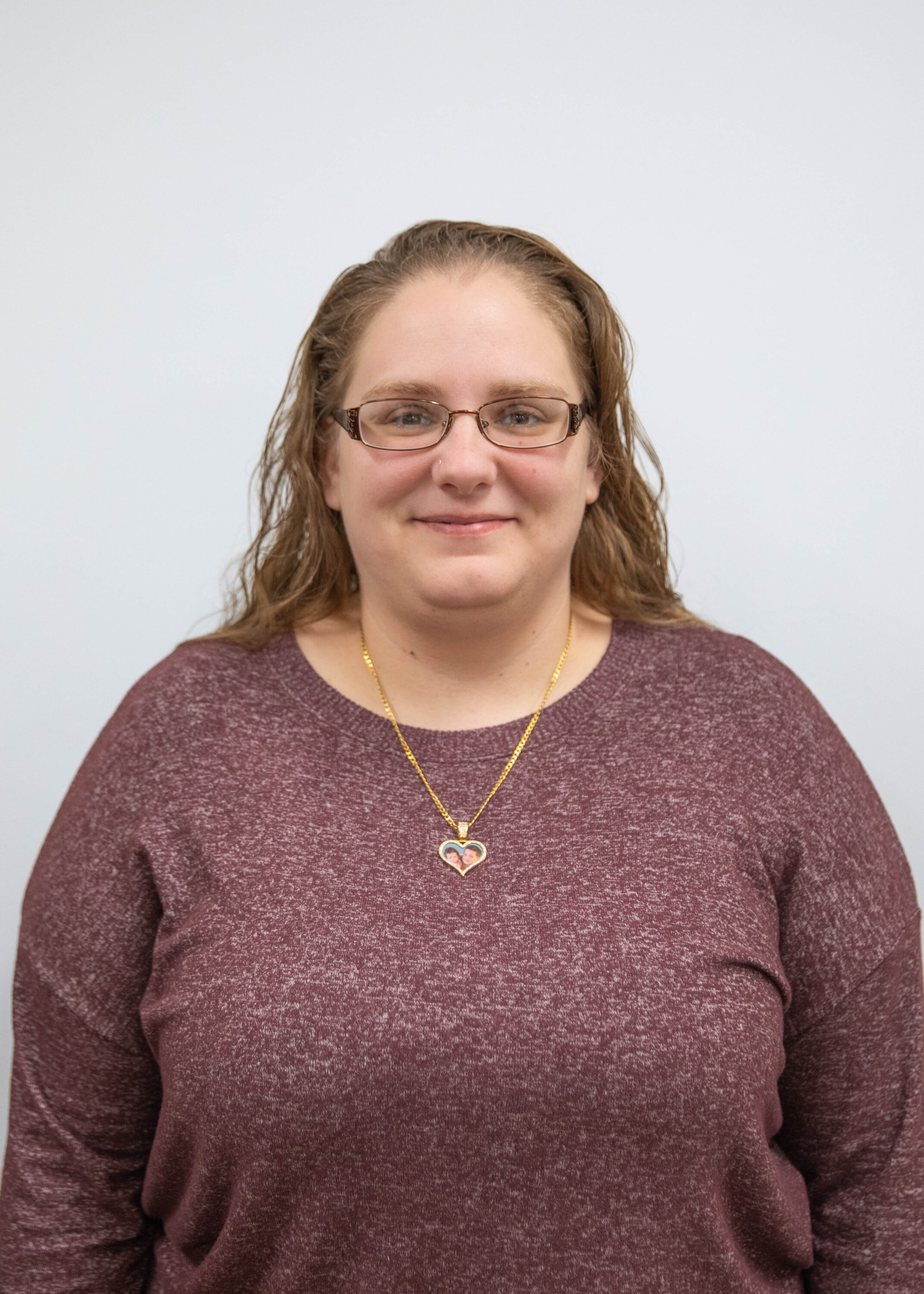 Woman wearing glasses and heart pendant necklace