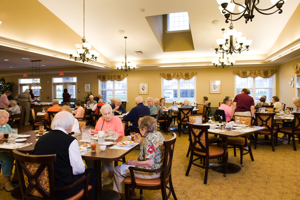 Seniors dining together in assisted living dining room