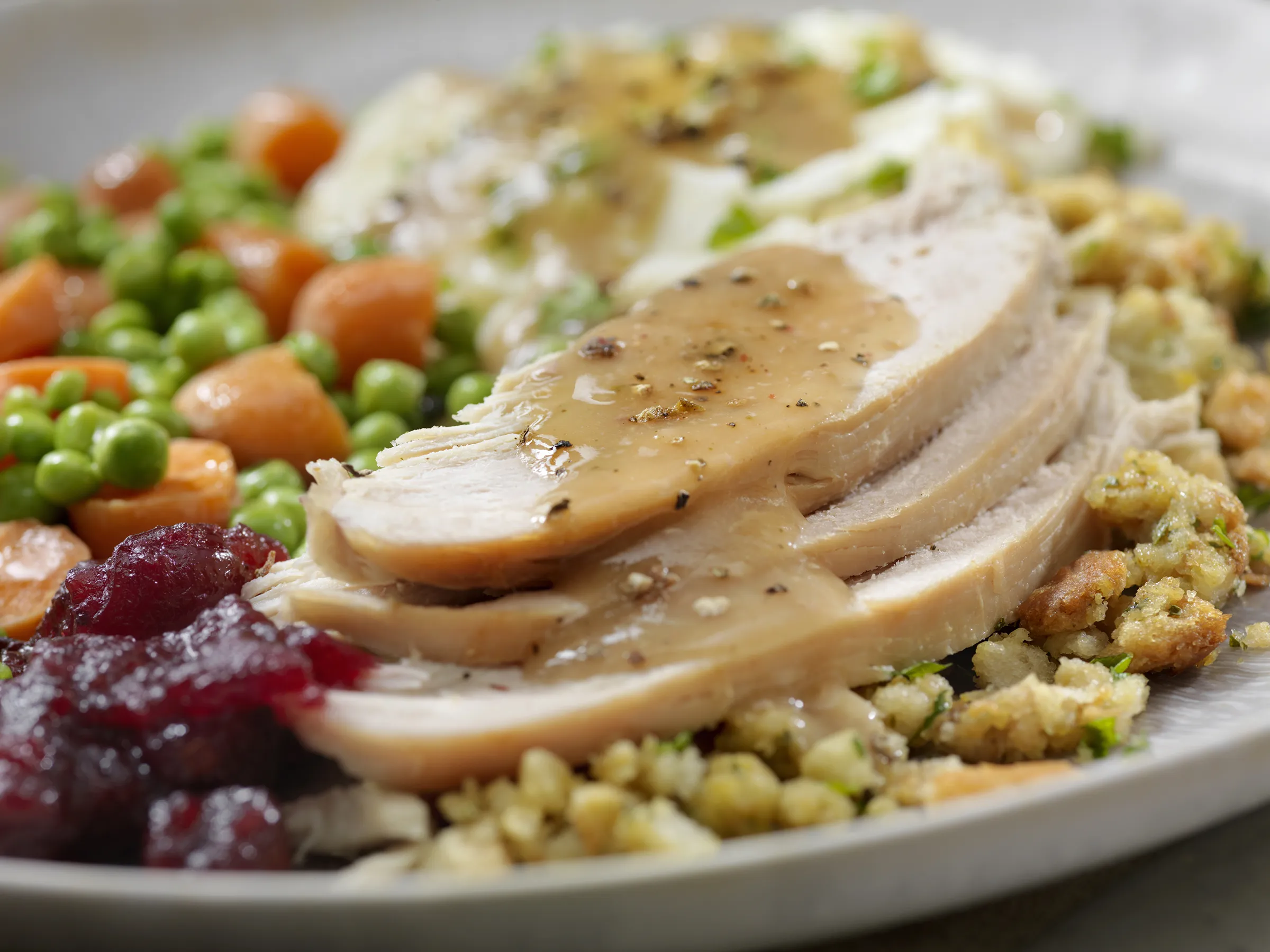Sliced roast turkey with gravy and sides