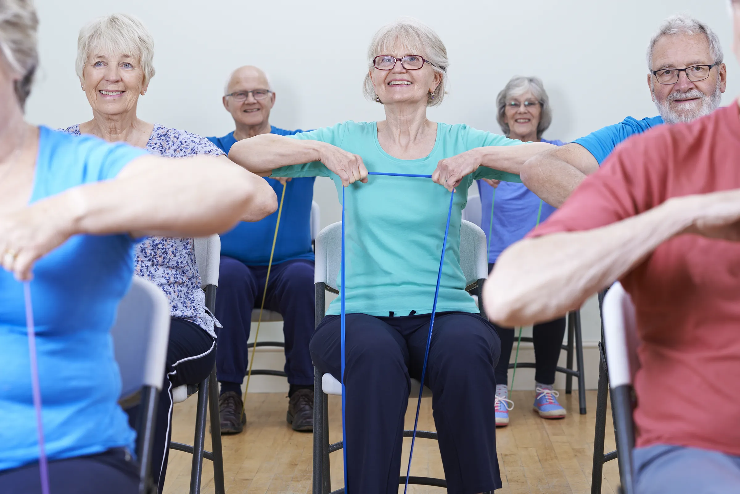 Seniors exercising with resistance bands in class