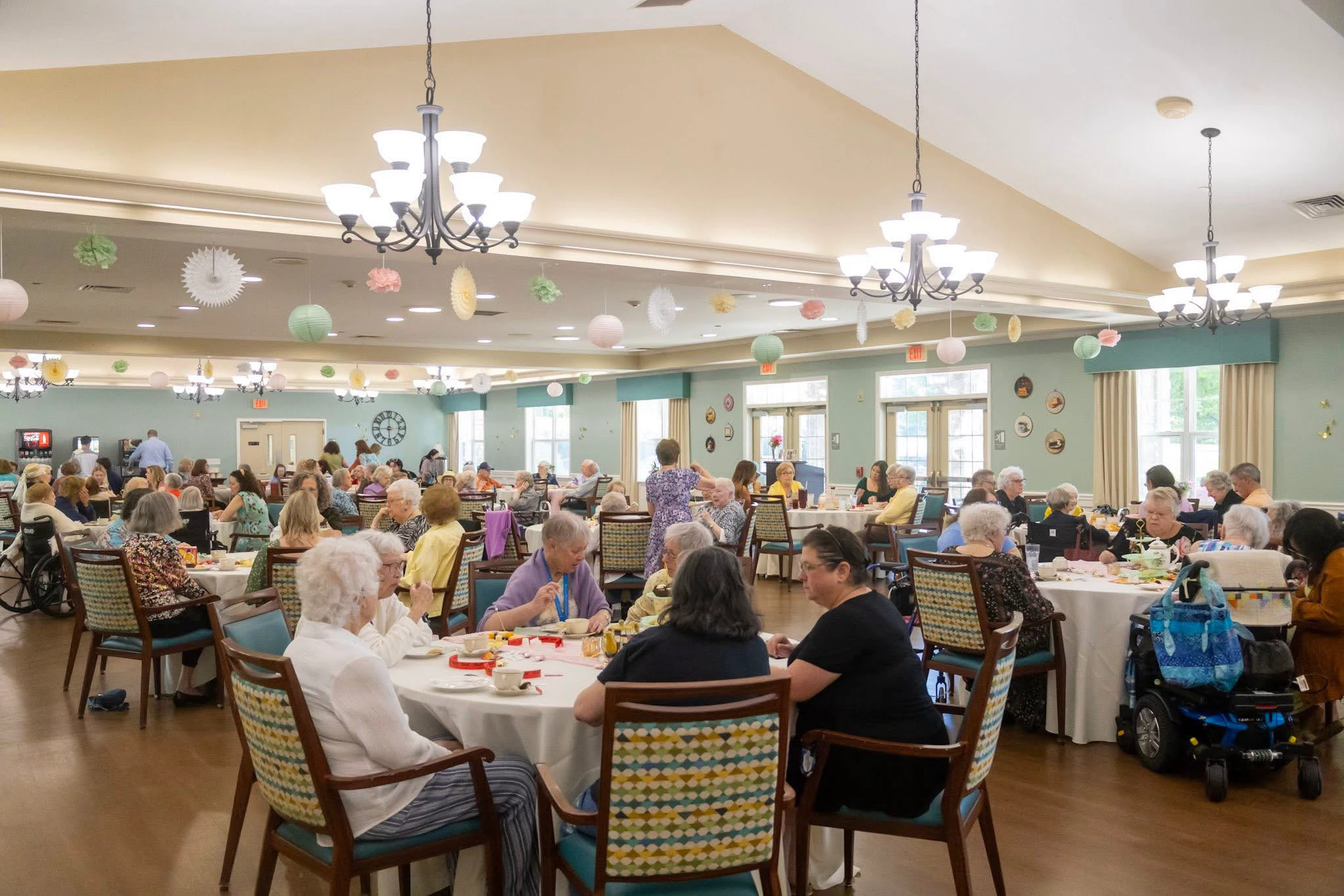 Seniors dining together in decorated community hall